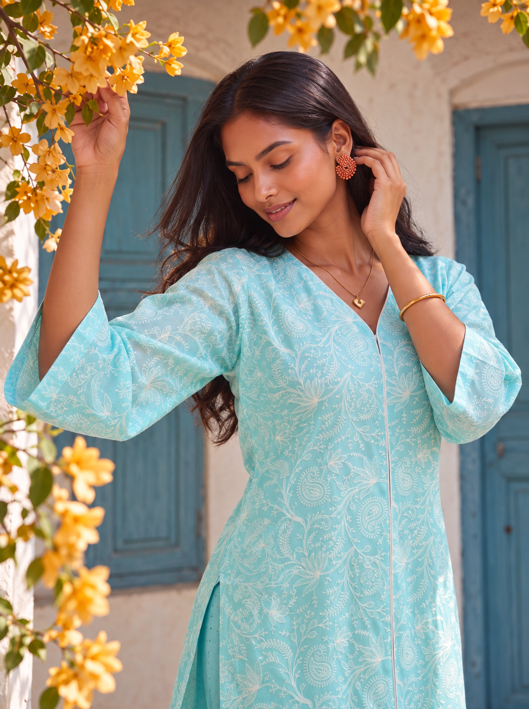 Discover the aqua blue embroidered kurta set by Lush Layers, featuring white paisley details, a V-neck and matching trousers for festive occasions.