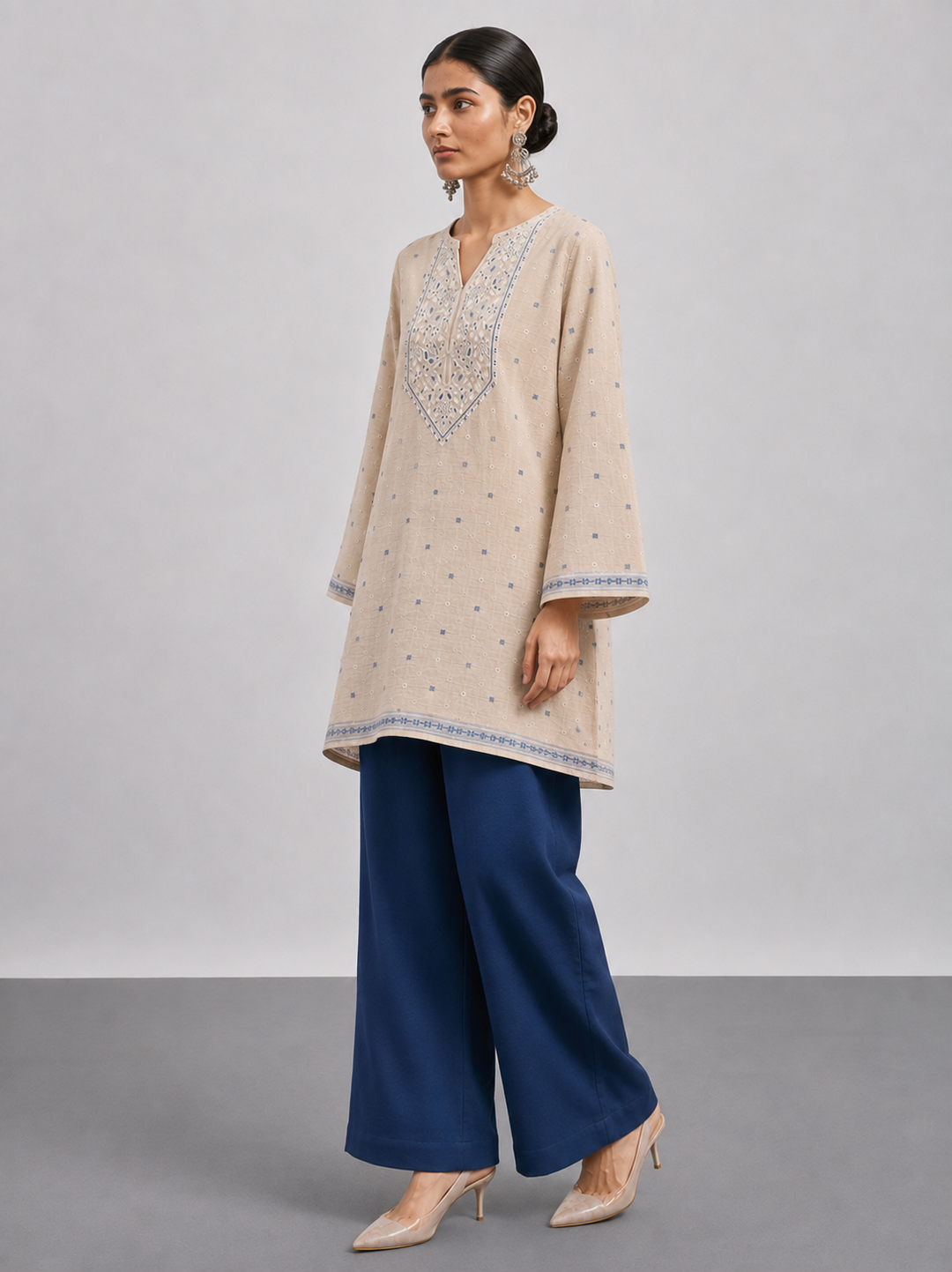 Shop this beige Chanderi embroidered suit set featuring intricate thread work, a coordinating blue bottom and botanical Chanderi dupatta. An elegant choice for festive and occasion wear.