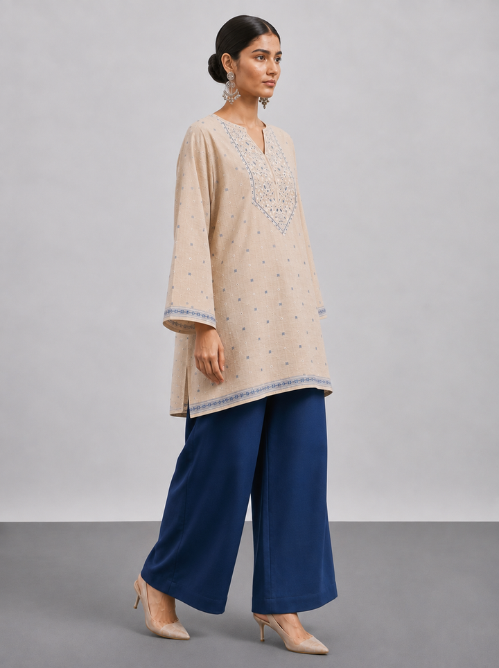 Shop this beige Chanderi embroidered suit set featuring intricate thread work, a coordinating blue bottom and botanical Chanderi dupatta. An elegant choice for festive and occasion wear.