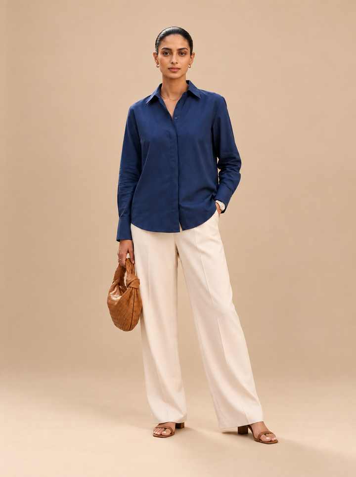 Shop the Navy Ease women’s shirt by Lush Layers, crafted in premium cotton with a comfortable 27-inch length. A versatile choice for office, everyday and smart-casual dressing
Clean. Comfortable. Effortlessly polished.
A navy blue shirt crafted in premium cotton with a relaxed silhouette and classic styling—an easy wardrobe essential for workdays and beyond.