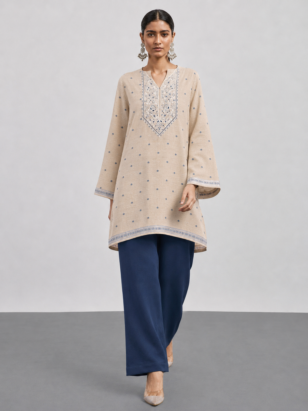 Shop this beige Chanderi embroidered suit set featuring intricate thread work, a coordinating blue bottom and botanical Chanderi dupatta. An elegant choice for festive and occasion wear.