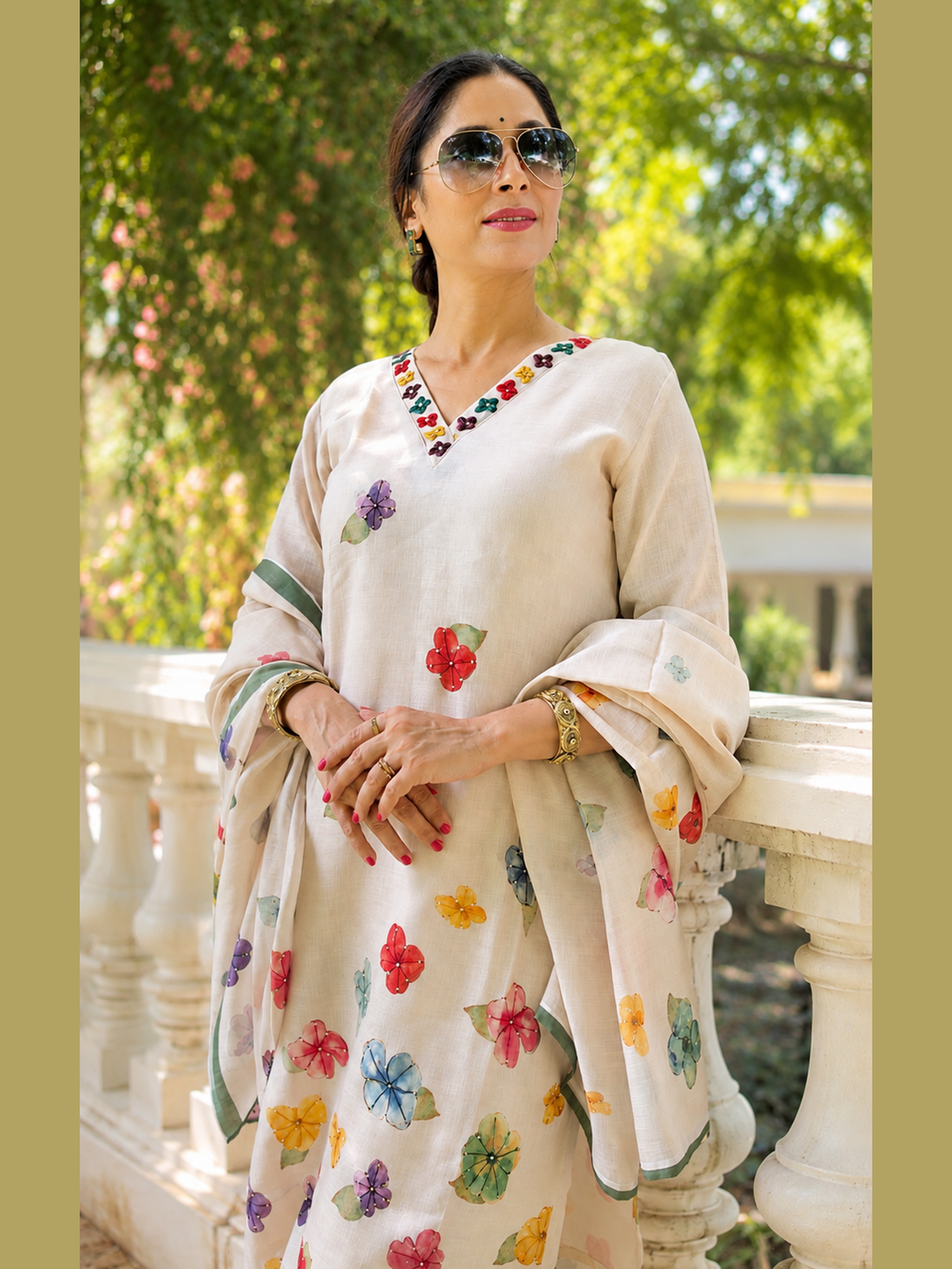 Shop this elegant beige linen festive set featuring floral motifs, delicate handwork, sequins, a V-neck kurta, coordinated bottoms and dupatta. A refined 3-piece ensemble for celebrations.