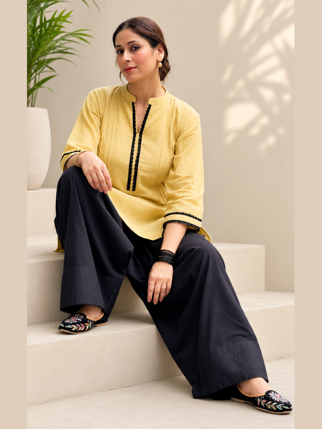 Beige women’s kurta with black detailing and black farshi salwar by Lush Layers