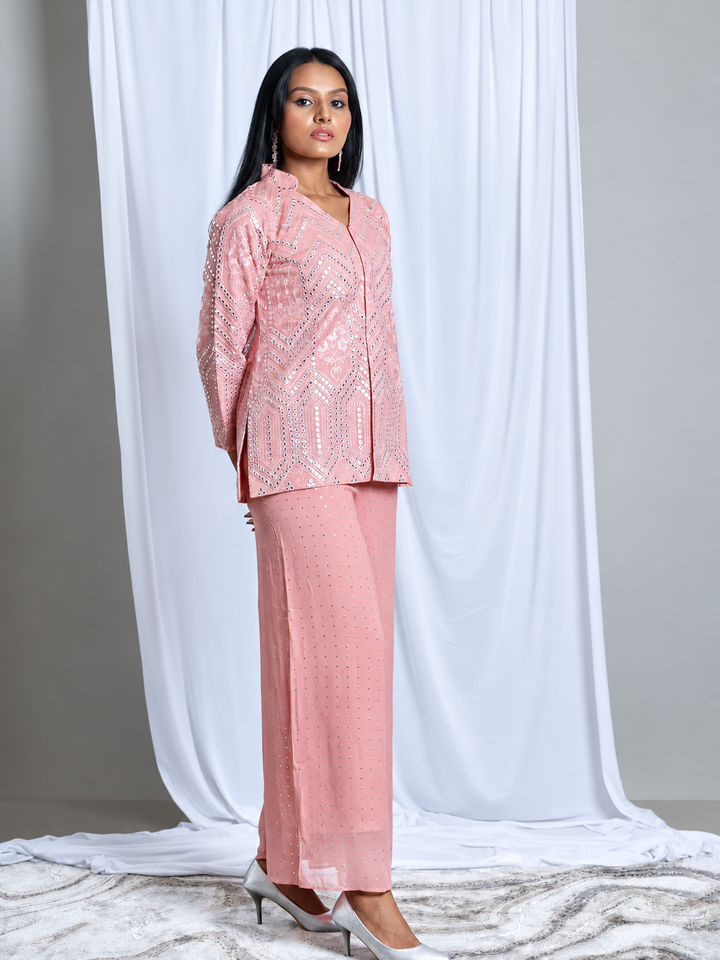 Shop the Baby Pink Embroidered Set by Lush Layers, featuring a detailed jacket-style top and matching wide-leg trousers for festive and evening occasions. Model wearing a baby pink embroidered jacket-style top with matching embellished wide-leg trousers.