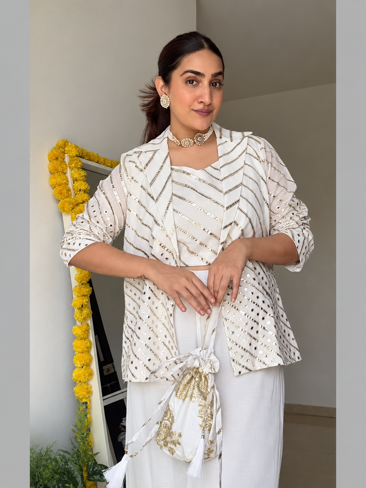 Discover the Ivory Chanderi Embroidered Jacket Set by Lush Layers. An elegant three-piece Indo-western ensemble for festive gatherings and celebrations.
